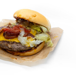 Closeup of big beef hamburger with vegetable and ketchup