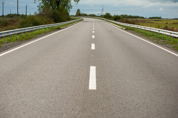 Smooth asphalt road with bumpers and markings