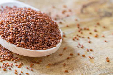 garden cress seeds in the wooden spoon (Lepidium sativum), curly cress on a wooden table