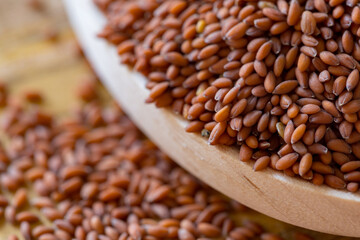 garden cress seeds in the wooden spoon (Lepidium sativum), curly cress on a wooden table