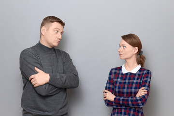 Portrait of serious focused man and woman looking at each other