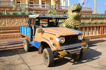 Old small pickup truck stands at Buddhist Temple 1