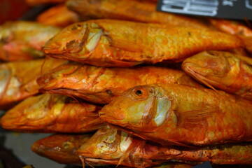 Smoked sea bass on the counter at the fair