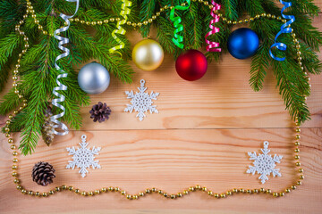 Wooden Christmas background with fir branches, Christmas balls, garlands and decorations