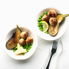 Meat balls for lunch with grilled eggplant and fresh green peas as a garnish. Healthy snack balanced diet. Top view