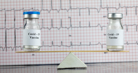 concept of the balance of two vaccine  on wooden scales