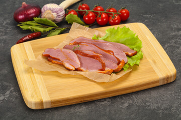 Sliced smoked duck breast served salad