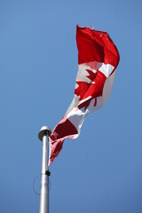canadian flag on blue sky