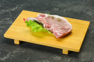 Raw pork bone steak over wooden