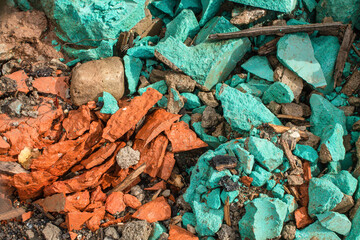 Bright background of colored stones, the main color is turquoise. Wet stones after rain. Bright background of colored stones.