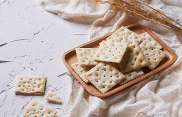 homemade square crackers on white table
