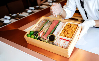 The chef presents the premium fresh ingredients in a wooden box before making the omakase meal such as Bluefin tuna (Toro and Chutoro), Uni, raw shrimps, truffle, wasabi and caviar.