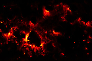 Fototapeta na wymiar Burning coal at night. Dark abstract texture background