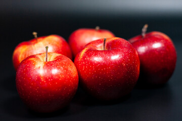 Ripe red apples on a dark background. Healthy natural color of the fruit. 