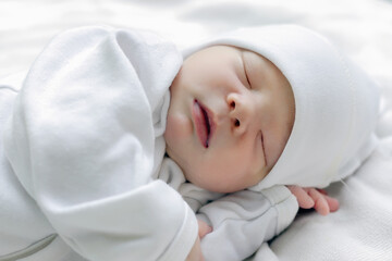 adorable newborn baby sleeping sweetly in crib