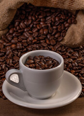 Coffee cup with coffee bag on wooden table