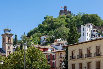 View from Plaza Nueva in Granada, with the church of Santa Ana to one side and the Torre de la Vela on the hill of the Alhambra