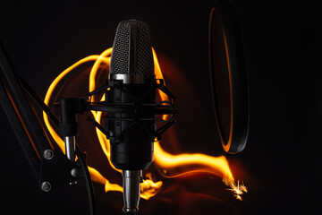 Professional microphone on professional tripod with shock mount and pop filter on dark background...