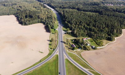 Top view of the long highway autobahn through the fields