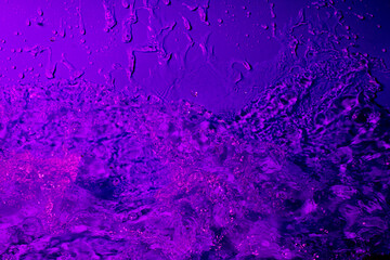 splash of water in lilac light. Abstract wallpaper