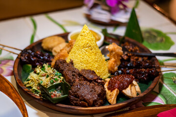 Freshly cooked dinner platter with nice decoration of rice and meat in a restaurant in Bali
