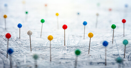 Multi-colored pins on the city map as a search symbol. Find your way among the many. Concept on the...