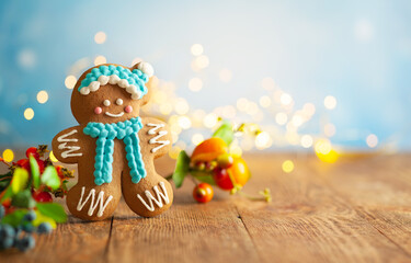 Christmas gingerbread cookies with Christmas decorations on wooden background.