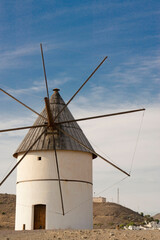 Fototapeta na wymiar white windmill in the spain desert