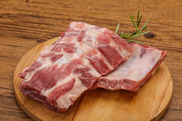 Raw pork ribs served rosemary