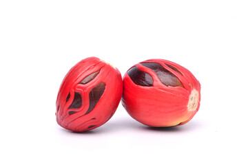 Close-up fresh nutmeg seeds with mace isolated on white background