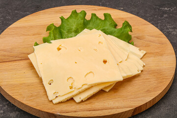 Sliced yellow cheese over board