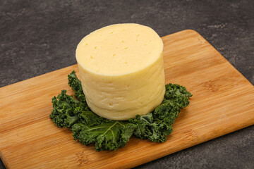 Yellow round dairy soft cheese