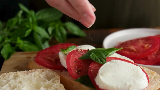 Chef garnish caprese sandwich with crushed black pepper. Gourmet italian sandwich