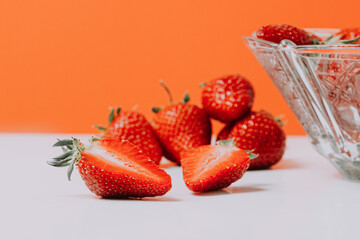 Fresh strawberry in ceramic jar on white