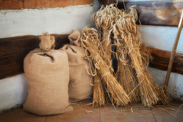 Sheaves of wheat spikelets and bags of flour.