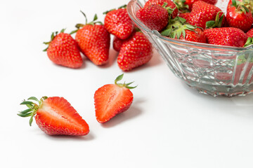 Fresh strawberry in ceramic jar on white
