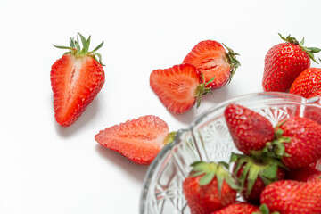 Fresh strawberry in ceramic jar on white