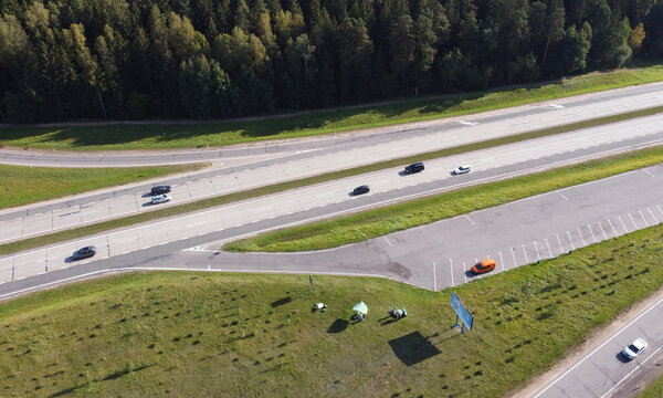 Top View Of Car Asphalt Highway With Cars Through Fields