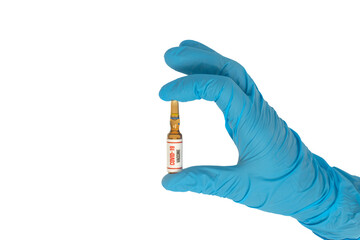 Drugs for coronavirus (covid 19) pandemic virus isolated on a white background, held by a blue doctor glove. Medicines used in virus treatment. The medicine capsule in the doctor's hand.