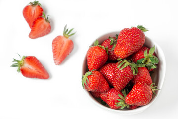 Fresh strawberry in ceramic jar on white