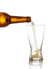 Beer bottle pouring beer in a glass, white background, closeup view
