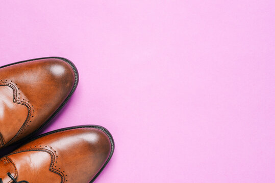 Mens shoes made of genuine leather. Brown shoes on a colored background with a copy of the space. The concept of selling shoes