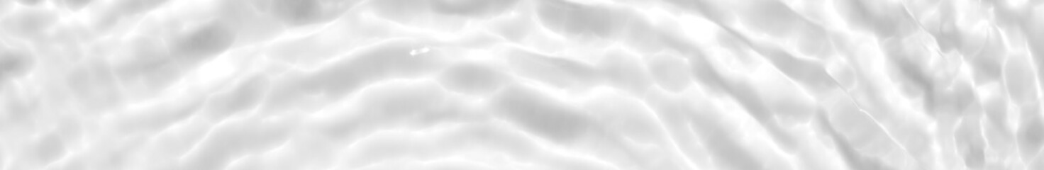 Photo of water waves shadow. Subtle white texture of light-shadow pattern of sunlight reflection from rippled water surface. Beautiful natural wallpaper. White-grey water waves marbling.