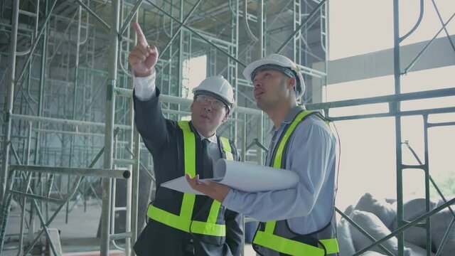 Engineer concept. Business people plan construction work in the building. 4k Resolution.