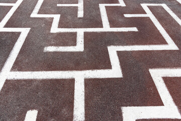 A white - painted maze on the sidewalk.