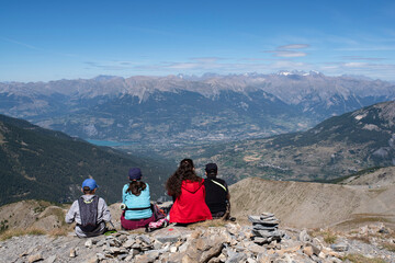 Fototapeta premium A family admiring a mountain landscape from a summit