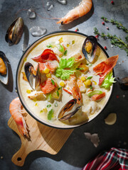 New England clam chowder, occasionally referred to as Boston or Boston-style Clam Chowder. Creamy soup with shrimp, corn, bacon and mussels