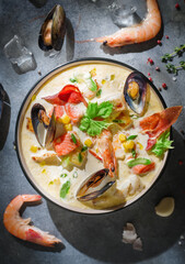 New England clam chowder, occasionally referred to as Boston or Boston-style Clam Chowder. Creamy soup with shrimp, corn, bacon and mussels