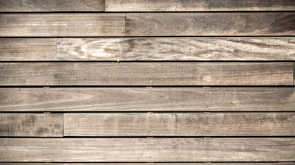 Fototapeta na wymiar Wall of gray wooden planks, slightly spaced 
