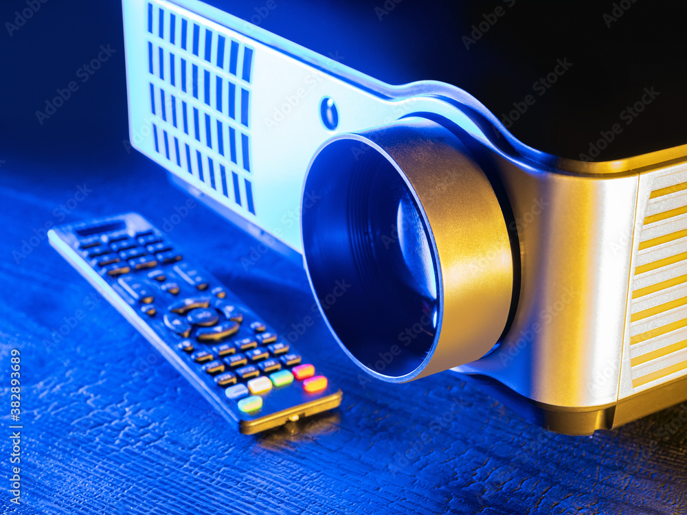 Poster multimedia projector with remote control close-up. equipment for viewing images and videos at home o